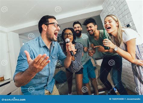 Friends Singing Together at Home. Karaoke Party Concept Stock Photo ...