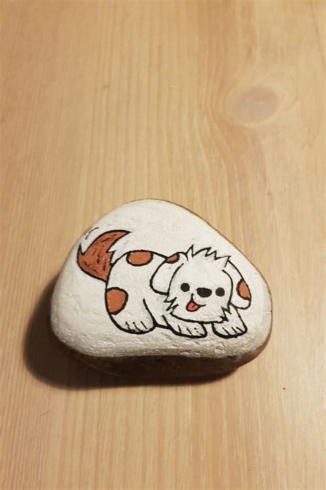 a rock with a dog painted on it