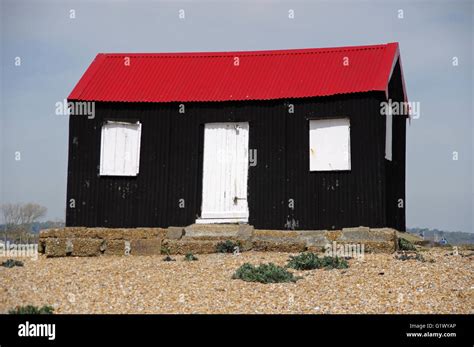 Black hut with red roof at Rye Harbour beach, East Sussex Stock Photo ...