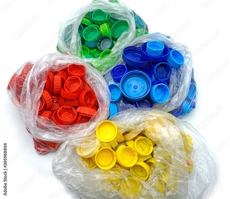 Colorful plastic bottle caps sorted by colors in transparent single use ...