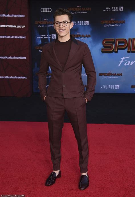 Looking good: Holland chose a natty maroon designer suit worn with a ...