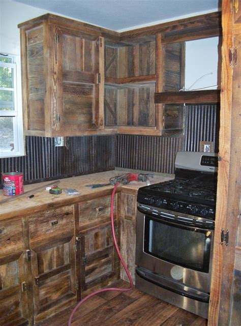 We built these barn wood cabinets and used old tin for a back splash ...