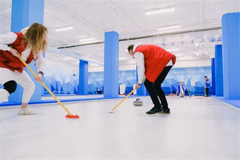 Team playing curling on ice sheet · Free Stock Photo