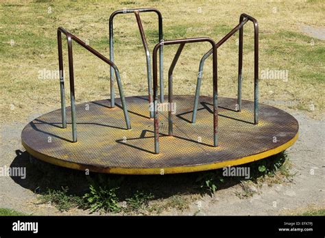 An old steel merry go round at a children's playground in Cotacachi ...