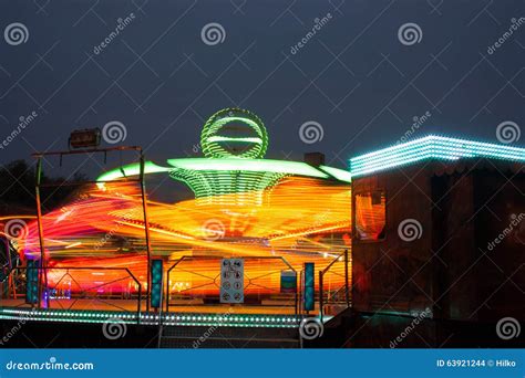 Carousels at night stock photo. Image of twist, movement - 63921244