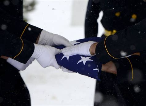 The Old Guard, folding a flag during a military honors funeral in ...