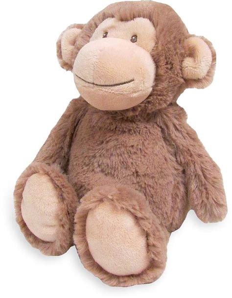 a brown stuffed monkey sitting up against a white background