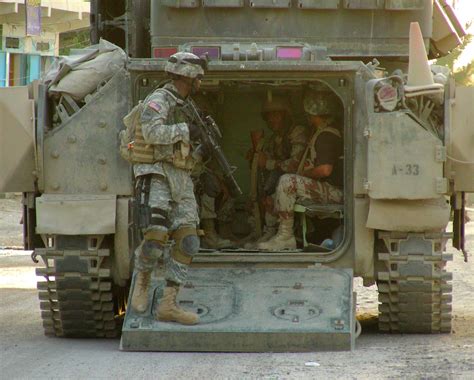 American and Iraqi troops share a Bradley fighting vehicle during a ...