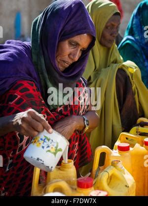 A woman sells camel milk in the market in Barawe, Somalia, on August 23 ...