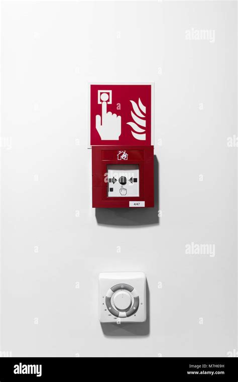 Red Fire alarm button on white wall Stock Photo - Alamy