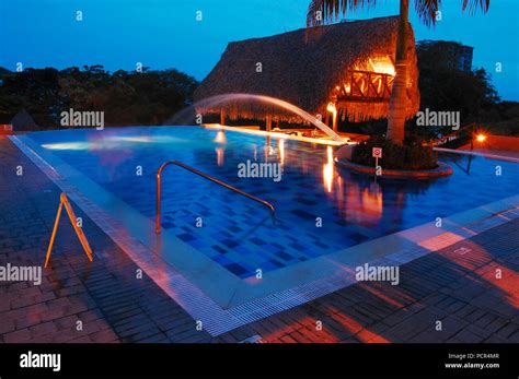 Resort swimming pool shot at night Stock Photo - Alamy