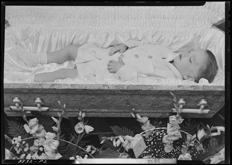 Jackie Hall; corpse of little boy; open casket surrounded by flowers