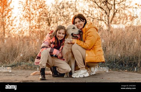 Girl with golden retriever dog Stock Photo - Alamy