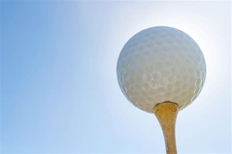 Premium Photo | Golf ball on tee close up