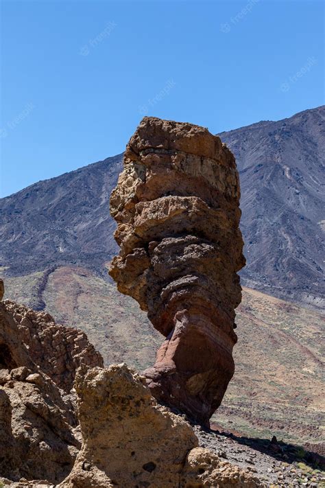 Premium Photo | A rock formation with a mountain in the background