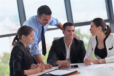 Group of happy young business people in a meeting at office - The Lynch ...