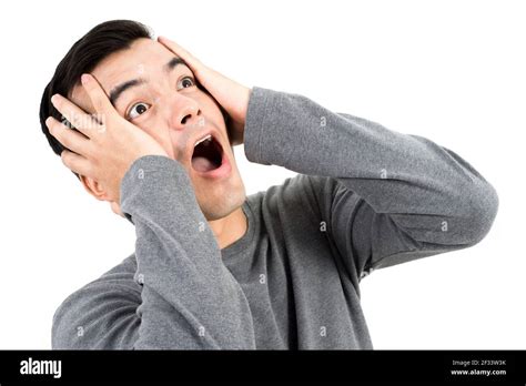 Young man expressing shocked face with hand on his heads Stock Photo ...