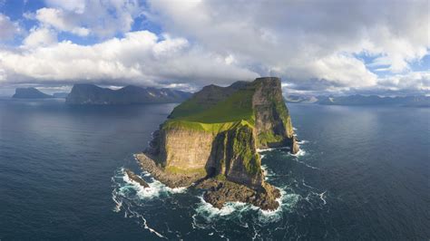 Aerial panorama of Kallur lighthouse and cliffs, Kalsoy island, Faroe ...