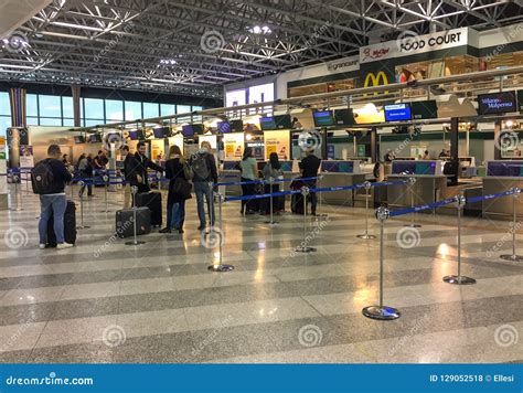 Passengers Lined Up For Chek-in Inside The Milan-Malpensa Airport ...