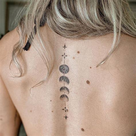 Fine line moon phases tattoo on the back.