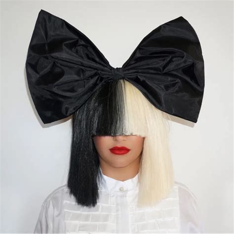 a mannequin wearing a black and white wig with a large bow on it's head