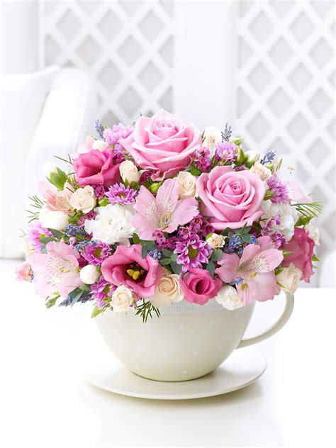 Pastel Teacup and Saucer Arrangement - Interflora | Beautiful flower ...