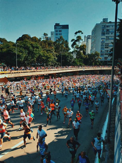 Diverse people running marathon on crowded road · Free Stock Photo