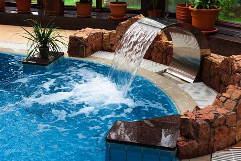 13 Beautiful Pool Waterfalls for Your Backyard Oasis