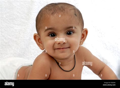 South Asian Indian baby ; smiling ; looking at camera ; India MR#152 ...