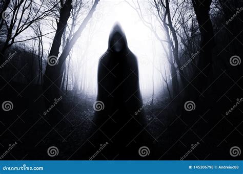 Hooded Ghost in Haunted Forest with Fog on Halloween Night Stock Photo ...