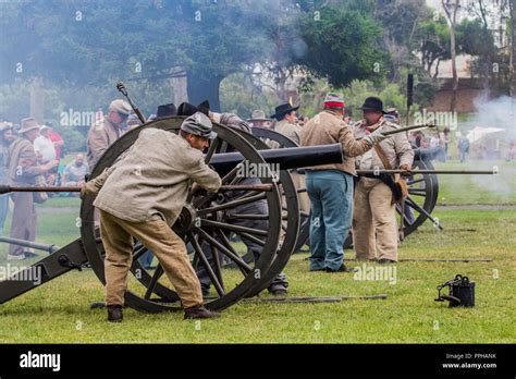 confederate soldiers firing a cannon during a battle at a American ...