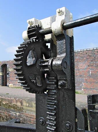 a close up of a metal object near a brick wall