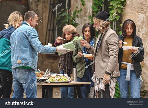 Volunteers Giving Food Homeless People Outdoors Stock Photo 1543550867 ...