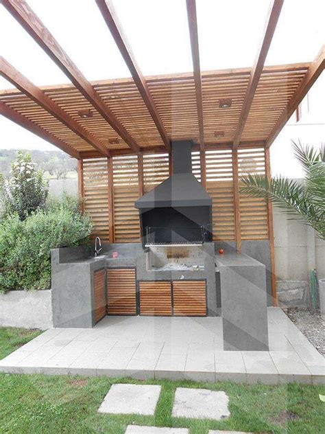 an outdoor bbq with grill and seating area