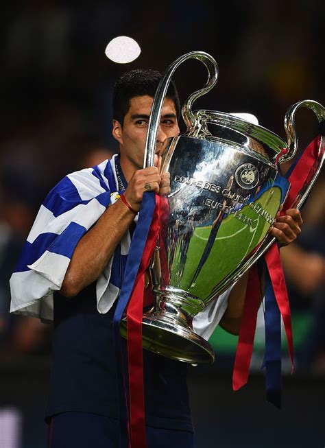 Luis Suarez of Barcelona kisses the trophy as he celebrates victory ...