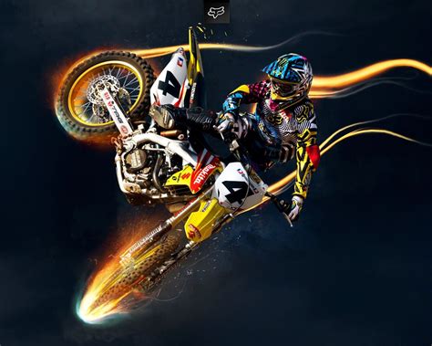 a person on a dirt bike in the air with flames coming out of their tires