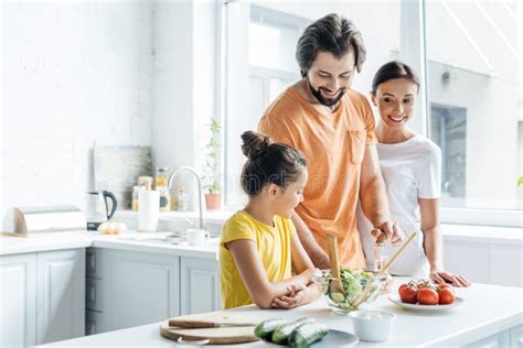 Smiling Young Family Cooking Together and Having Fun Stock Image ...