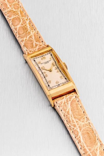 PATEK PHILIPPE. A LADY’S 18K GOLD RECTANGULAR WRISTWATCH , REF. 138 ...