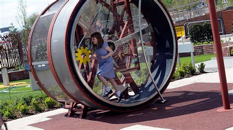 A child enjoying spinning around the huge human-sized hamster wheel in ...