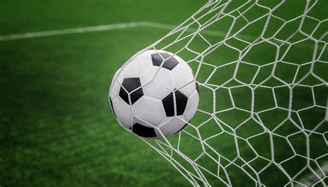 Soccer ball on goal with net and green background Photograph by Anek ...