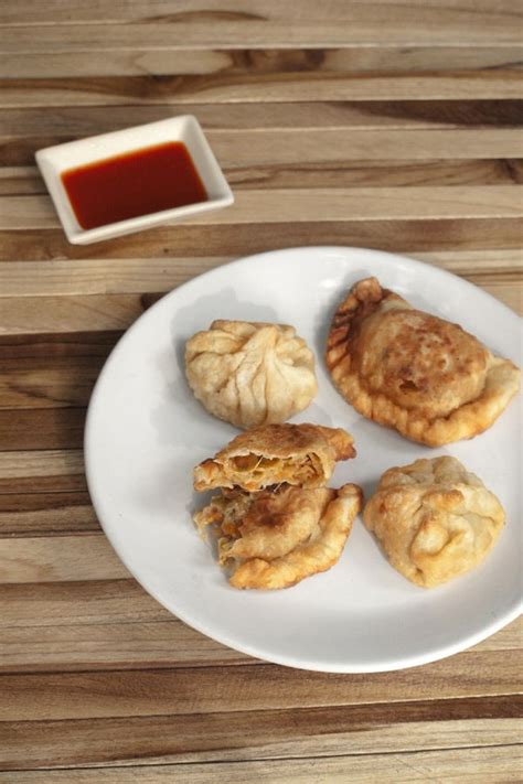 Momos Recipe easily made at home with a veg cheese filling and fried ...