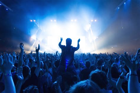 crowd of people at concert in front of the stage with lights - Music ...