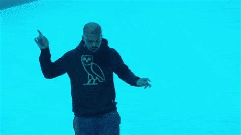 a man standing in front of a blue screen with an owl on it's shirt