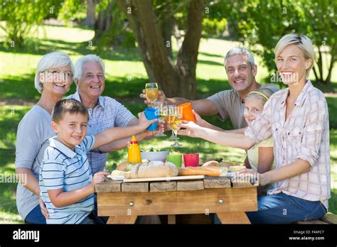 Happy family having picnic in the park Stock Photo - Alamy