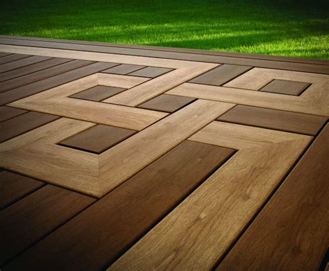 a wooden deck that has squares and rectangles on it, with grass in the ...