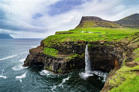 Gasadalur waterfall into the ocean, Vagar, Faroe Islands, Denmark ...