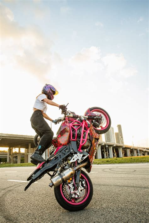 A Woman Doing a Stunt on a Motorcycle · Free Stock Photo