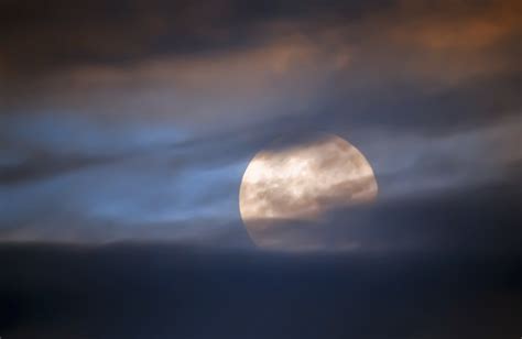 Full moon behind clouds - The News Room