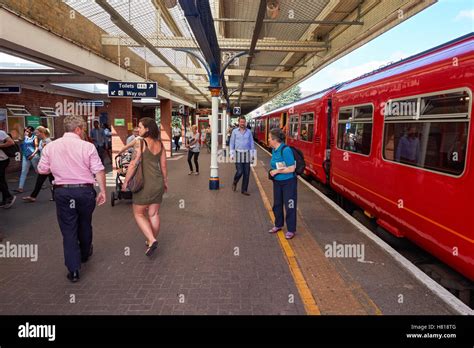 Passengers at Kingston railway station in Kingston upon Thames, England ...