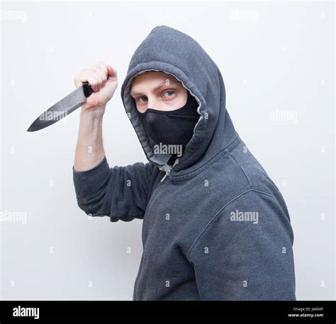 masked man holding knife Stock Photo - Alamy